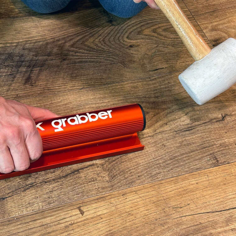 Load image into Gallery viewer, Floor Fix Pro Plank Grabber Plank Grabber is a tool for fixing gaps in floating floors. It features a &quot;Magic Grip Strip&quot; that sticks to the plank you want to move using nano-suction and without leaving any sticky residue. Plank Grabber can be used to fix
